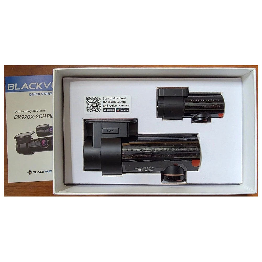 BlackVue DR970X-2CH Pro camera system in packaging with user manual on a white background